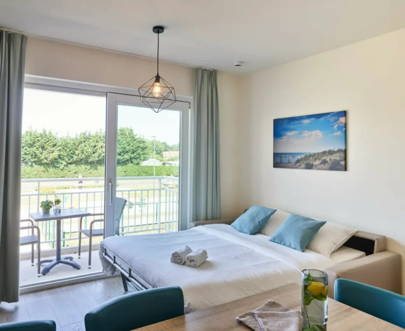 Slaapruimte bij het balkon bij Holiday Suites Nieuwpoort